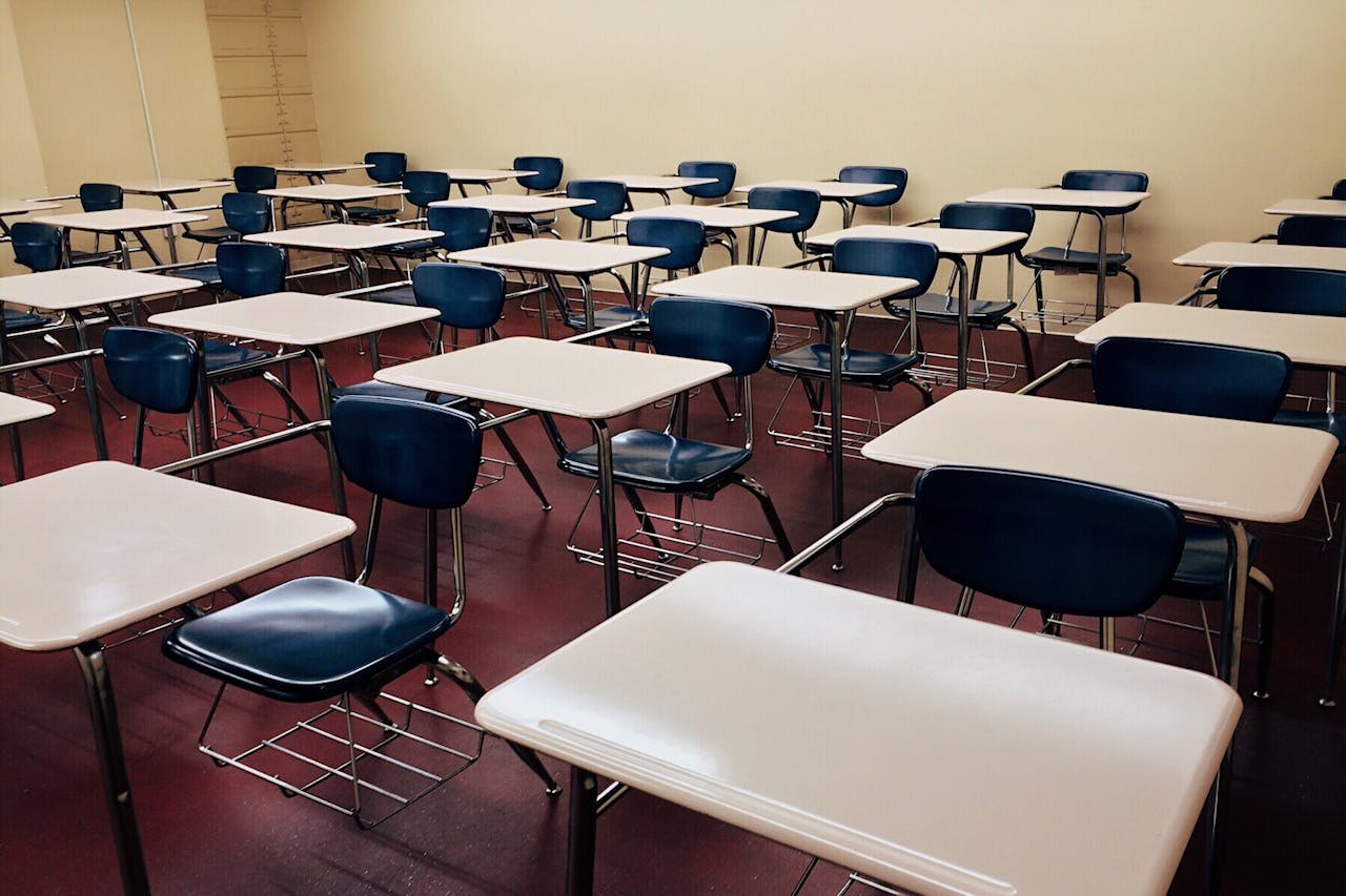The Art of Drawing Readers In: Your attractive post title goes here An empty classroom featuring neatly arranged desks and chairs ready for use.
