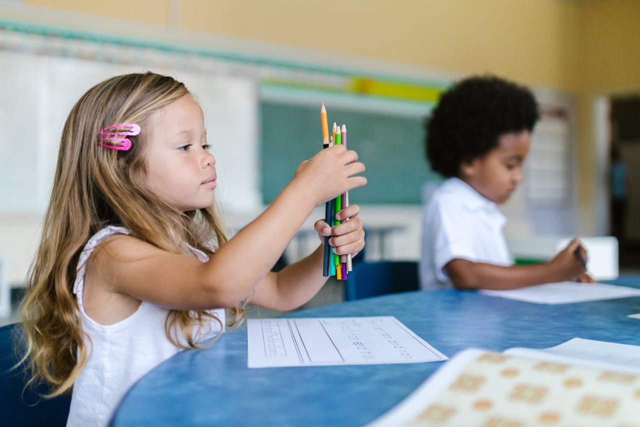 Crafting Captivating Headlines: Your awesome post title goes here Two children focused on classroom learning with colored pencils and paper.